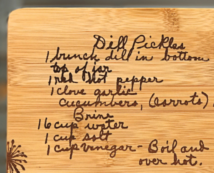 closeup of handwriting laser engraved on bamboo cutting board